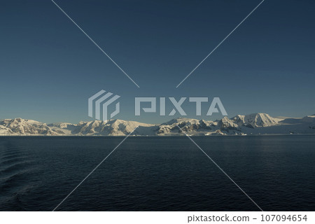 Lemaire strait coastal landscape, mountains and icebergs, Antarctic Peninsula, Antartica. Lemaire strait coastal landscape, mountains and icebergs, Antarctic Peninsula, Antartica. 107094654