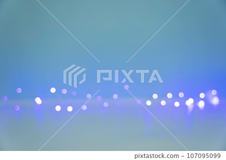 Blurred light bulbs of a light garland glowing on a blue-white background Blurred light bulbs of a light garland glowing on a blue-white background 107095099