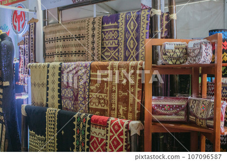 woman is weaving cloth, or so-called traditional tapis cloth, typical of Lampung province, by hand 107096587