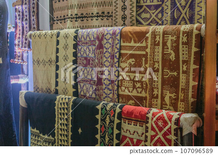 woman is weaving cloth, or so-called traditional tapis cloth, typical of Lampung province, by hand 107096589