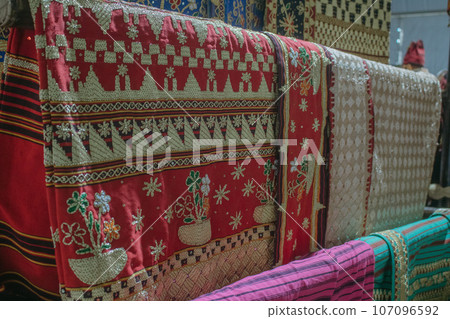 woman is weaving cloth, or so-called traditional tapis cloth, typical of Lampung province, by hand 107096592