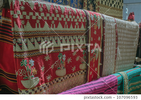 woman is weaving cloth, or so-called traditional tapis cloth, typical of Lampung province, by hand 107096593
