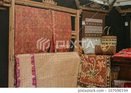 woman is weaving cloth, or so-called traditional tapis cloth, typical of Lampung province, by hand 107096594