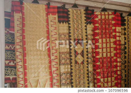 woman is weaving cloth, or so-called traditional tapis cloth, typical of Lampung province, by hand 107096596