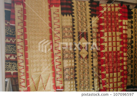 woman is weaving cloth, or so-called traditional tapis cloth, typical of Lampung province, by hand 107096597