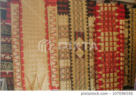 woman is weaving cloth, or so-called traditional tapis cloth, typical of Lampung province, by hand 107096598