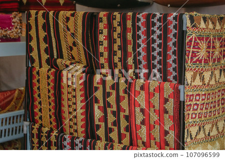 woman is weaving cloth, or so-called traditional tapis cloth, typical of Lampung province, by hand 107096599