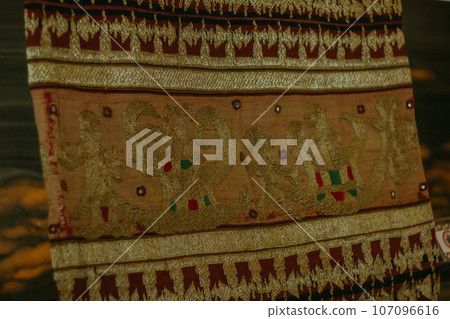 woman is weaving cloth, or so-called traditional tapis cloth, typical of Lampung province, by hand 107096616