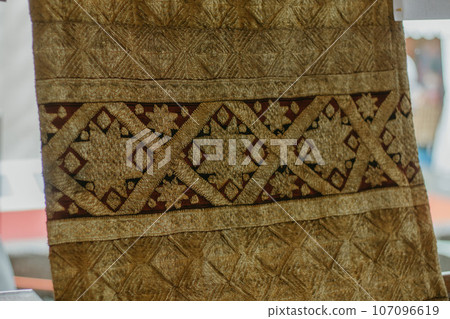 woman is weaving cloth, or so-called traditional tapis cloth, typical of Lampung province, by hand 107096619