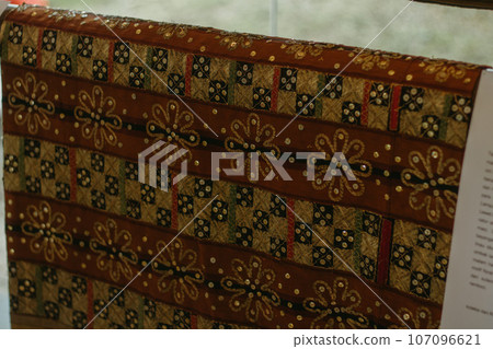 woman is weaving cloth, or so-called traditional tapis cloth, typical of Lampung province, by hand 107096621