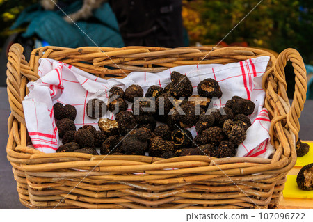 Expensive black truffles gourmet mushrooms in basket 107096722