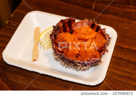 Fresh sea urchin on wooden table Fresh sea urchin on wooden table 107096853
