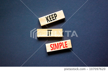 Keep it simple symbol. Concept word Keep it simple on beautiful wooden block. Beautiful black table black background. Business motivational keep it simple concept. Copy space. 107097620