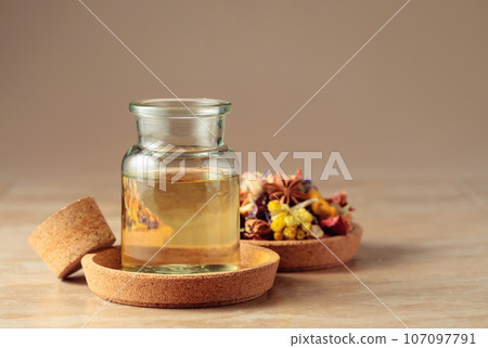 Essential oil or herbal tincture in a  small glass bottle. 107097791