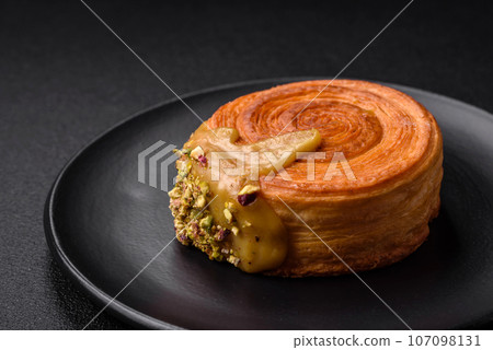 Round puff pastry croissant with raspberry filling or new york roll Round puff pastry croissant with raspberry filling or new york roll 107098131