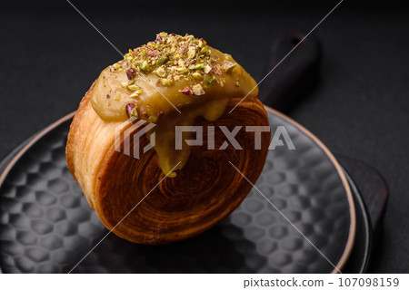 Round puff pastry croissant with raspberry filling or new york roll Round puff pastry croissant with raspberry filling or new york roll 107098159