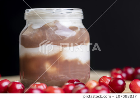 Yogurt with plum jam in a jar 107098837