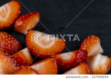 pieces of ripe strawberries of red color pieces of ripe strawberries of red color 107098849