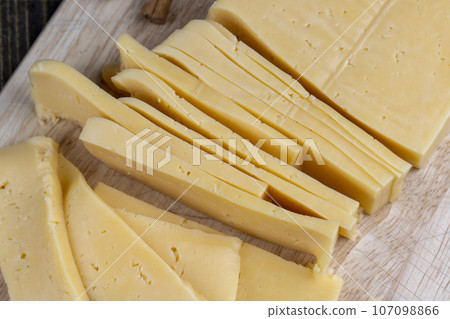 fresh cheese with holes cut into chunks fresh cheese with holes cut into chunks 107098866