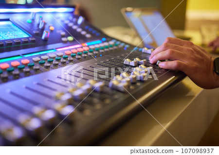 Sound mixer. Professional audio mixing console with lights, buttons, faders and sliders. 107098937