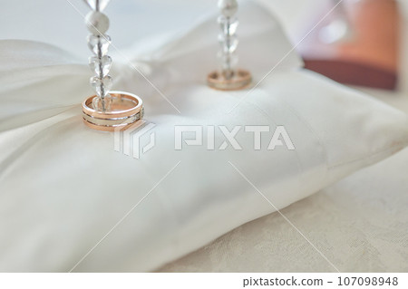 White pillow for wedding rings in a heart 107098948
