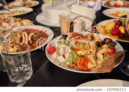large lunch set of three courses soup, second course and salad, Top view of a three course set menu served on wooden table, business lunch set made of three meals 107099111