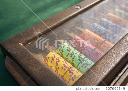Casino. Poker. Game pieces and dice are on the table. Game chips for betting in gambling. Dice. Poker chips. Casino. Poker. Game pieces and dice are on the table. Game chips for betting in gambling. Dice. Poker chips. 107099149