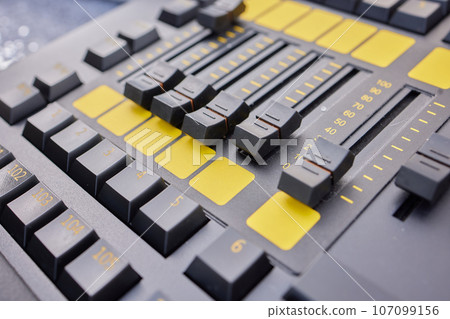 Man hands of sound engineer adjusting audio mixing console. 107099156