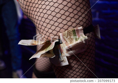 Young worker with earned money in brothel, closeup. Young worker with earned money in brothel, closeup. 107099173