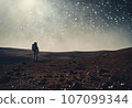 Astronaut on an icy rocky surface with the sky filled with stars and galaxies, AI-generated 107099344