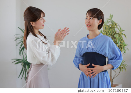Woman doing voice training under instructions from a voice trainer 3 107100587