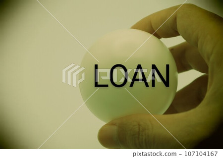 A person holding a ball with LOAN written on it A person holding a ball with LOAN written on it 107104167
