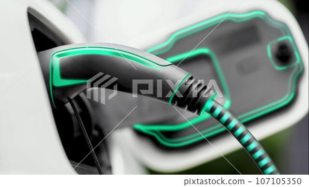 Future EV charger plugged into electric car for electric recharging. Peruse Future EV charger plugged into electric car for electric recharging. Peruse 107105350