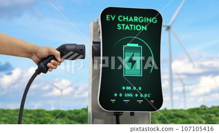 EV charger from EV car charging station at wind turbine. Persuse 107105416