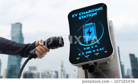 Hand pull and hold EV charger from empty screen charging station. Peruse 107105436
