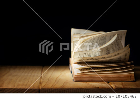 Spirituality, Religion and Hope Concept. Praying in the Dark Place. Supplication, Believe and Faith for Human. Hope in the midst of the Broken. Aged Bible on  Wooden  Table. Light Shining on subject. 107105462