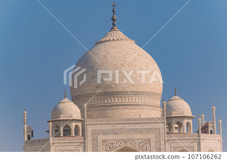 Garlic dome architecture of the Taj Mahal temple, Agra, Uttar Pradesh, India is built of white marble Garlic dome architecture of the Taj Mahal temple, Agra, Uttar Pradesh, India is built of white marble 107106262