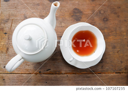 hot tea, tea cup and tea pot 107107235
