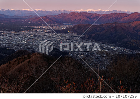 Sunrise over the Southern Alps and Fujiyoshida/Kawaguchiko city seen from Mt. Sunrise over the Southern Alps and Fujiyoshida/Kawaguchiko city seen from Mt. 107107259