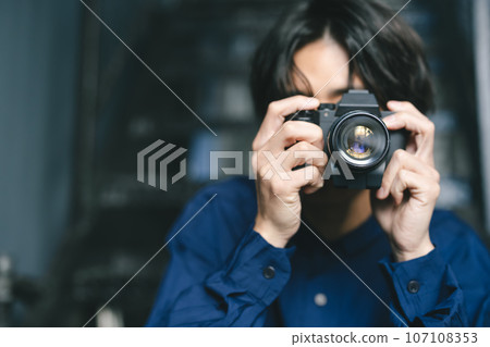 A man holding a camera A man holding a camera 107108353
