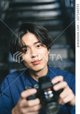 A man holding a camera A man holding a camera 107108355
