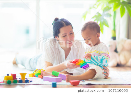Baby boy playing with toy 107110093