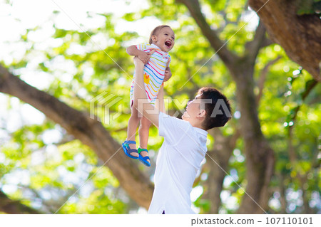 Teenage boy playing with his baby brother 107110101