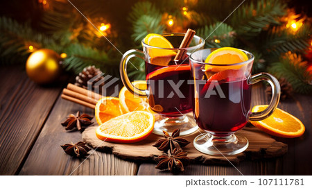 Two glasses of traditional christmas alcohol drink - mulled wine with cinnamon, anise and oranges 107111781