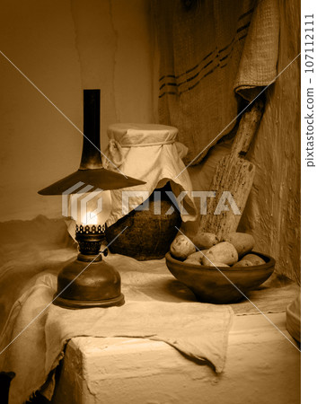Ancient still life. Potatoes with kerosene lamp Ancient still life. Potatoes with kerosene lamp 107112111