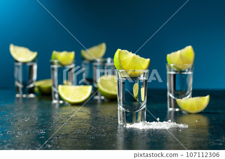 Tequila shots with lime slices and sea salt. Tequila shots with lime slices and sea salt. 107112306