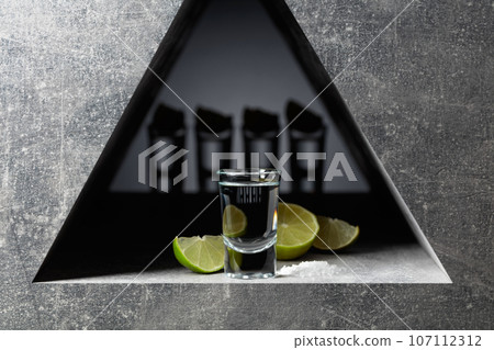 Tequila with lime slices and sea salt. 107112312
