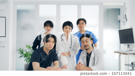 A group of medical workers talking while looking at the camera A group of medical workers talking while looking at the camera 107113841