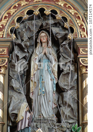 Our Lady of Lourdes statue on the altar in Parish Church of Saint Roch in Kratecko, Croatia 107114574