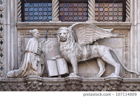 Detail of the Porta della Carta entrance to the Doge's Palace in Venice, Italy, depicting Doge Francesco Foscari kneeling before the Lion of St. Mark Detail of the Porta della Carta entrance to the Doge's Palace in Venice, Italy, depicting Doge Francesco Foscari kneeling before the Lion of St. Mark 107114809